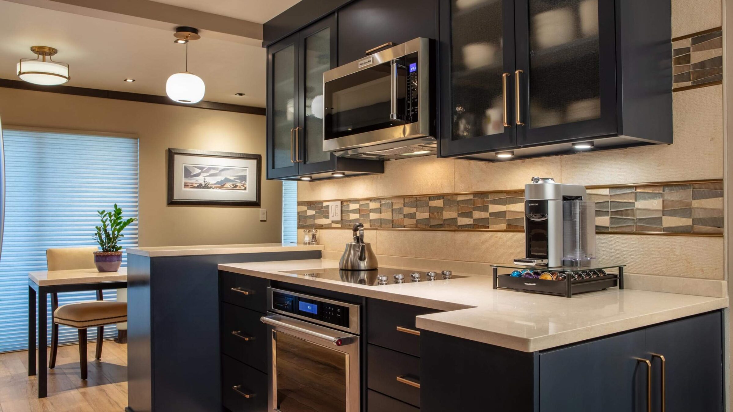 Modern kitchen featuring navy cabinets.